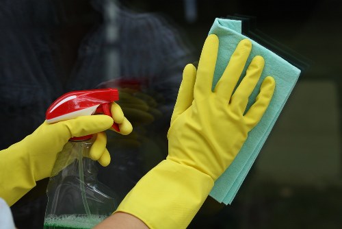 Cleaner wearing gloves and inspecting a safe work area
