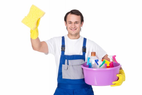 Trained cleaner using proper PPE during a cleaning task