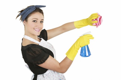 Cleaner placing a wet floor warning sign during routine work