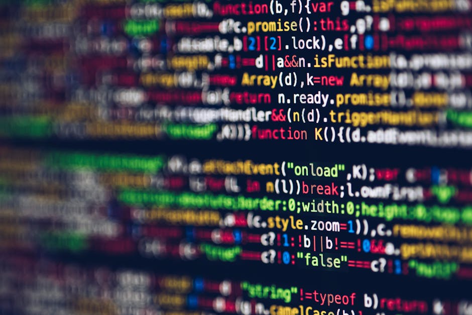 A close-up view of a computer screen displaying colorful lines of programming code, including syntax highlighting with various colors such as red, blue, green, yellow, and white. The code contains key